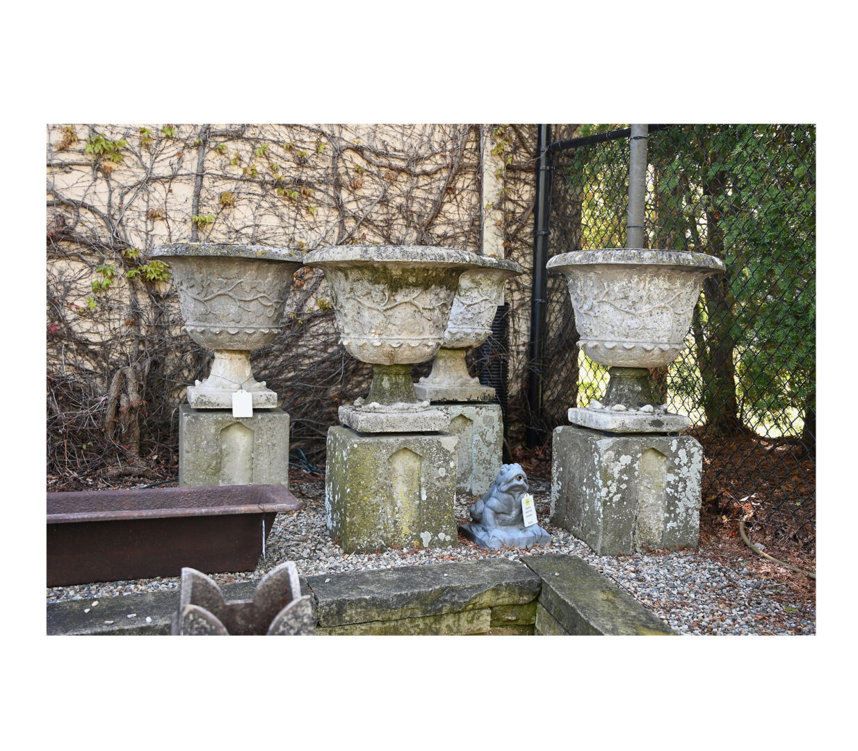 Set of Four Weathered Urns on Bases