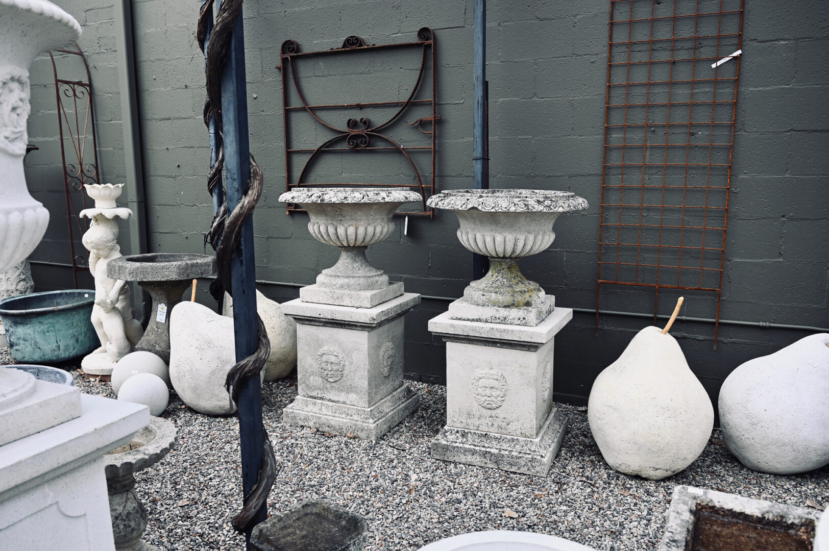 Pair of Large Weathered Urns on Pedestals